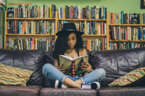 Girl reading a book rather than playing video games