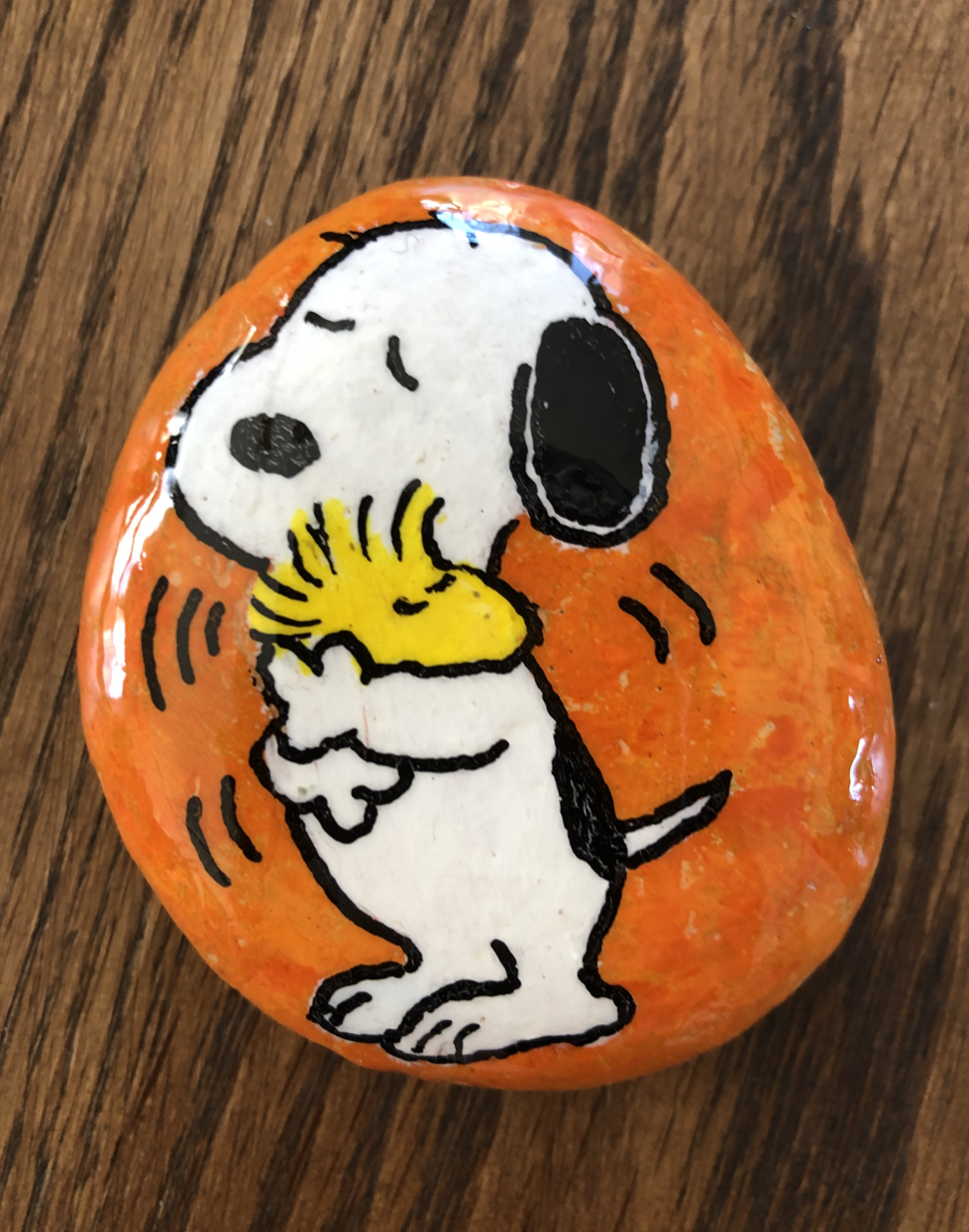 Rock with snoopy consoling his friend