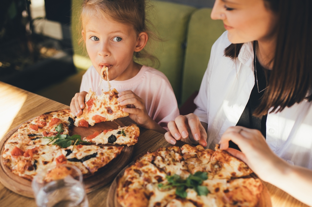 Kid and mom eating pizza