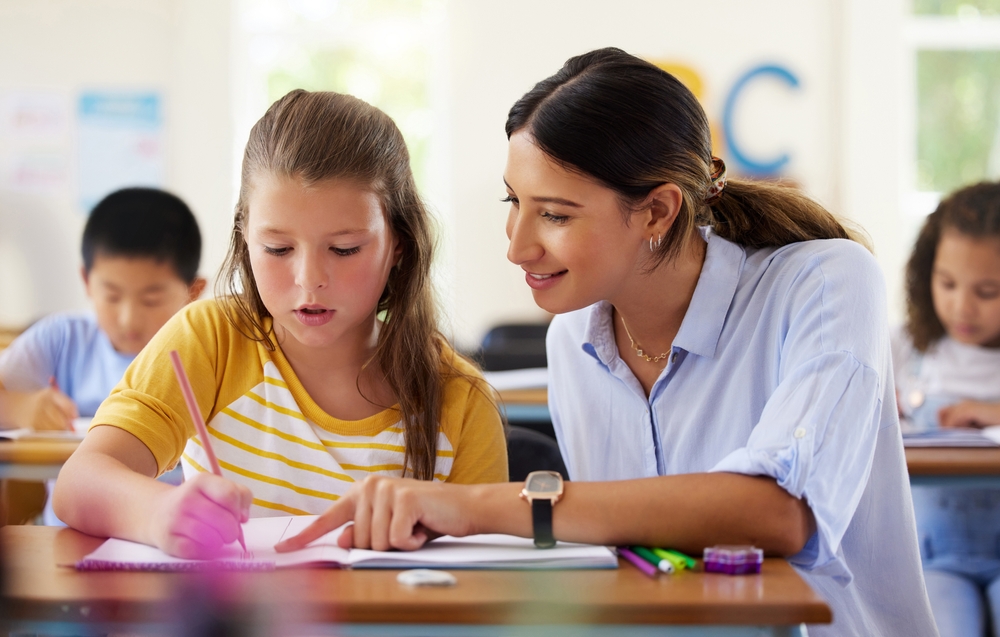Teacher working with child, trusting that "Kids do well if they can."