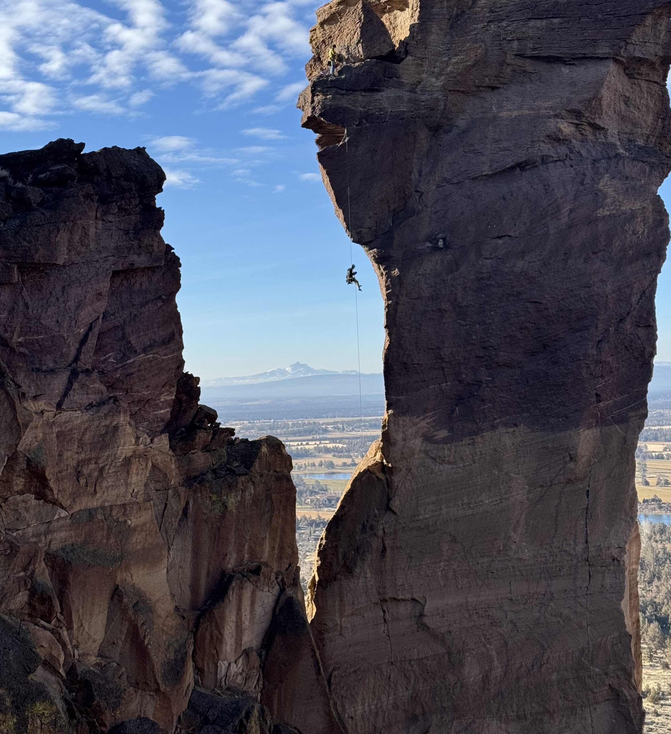 Person scaling mountain rock climbing